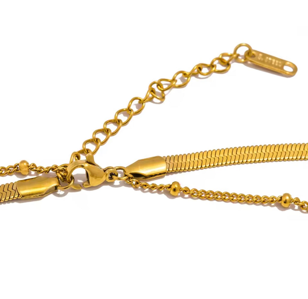 Gold chain necklace on a white background