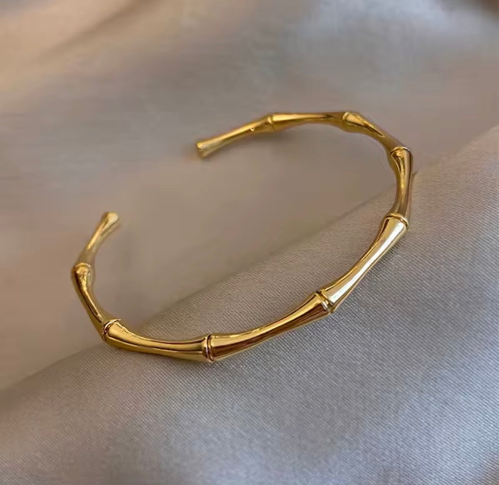 Shop The Kaori Bangle – a bamboo-inspired 316L stainless steel open bangle with 18K PVD gold plating. Waterproof, tarnish-resistant and hypoallergenic.