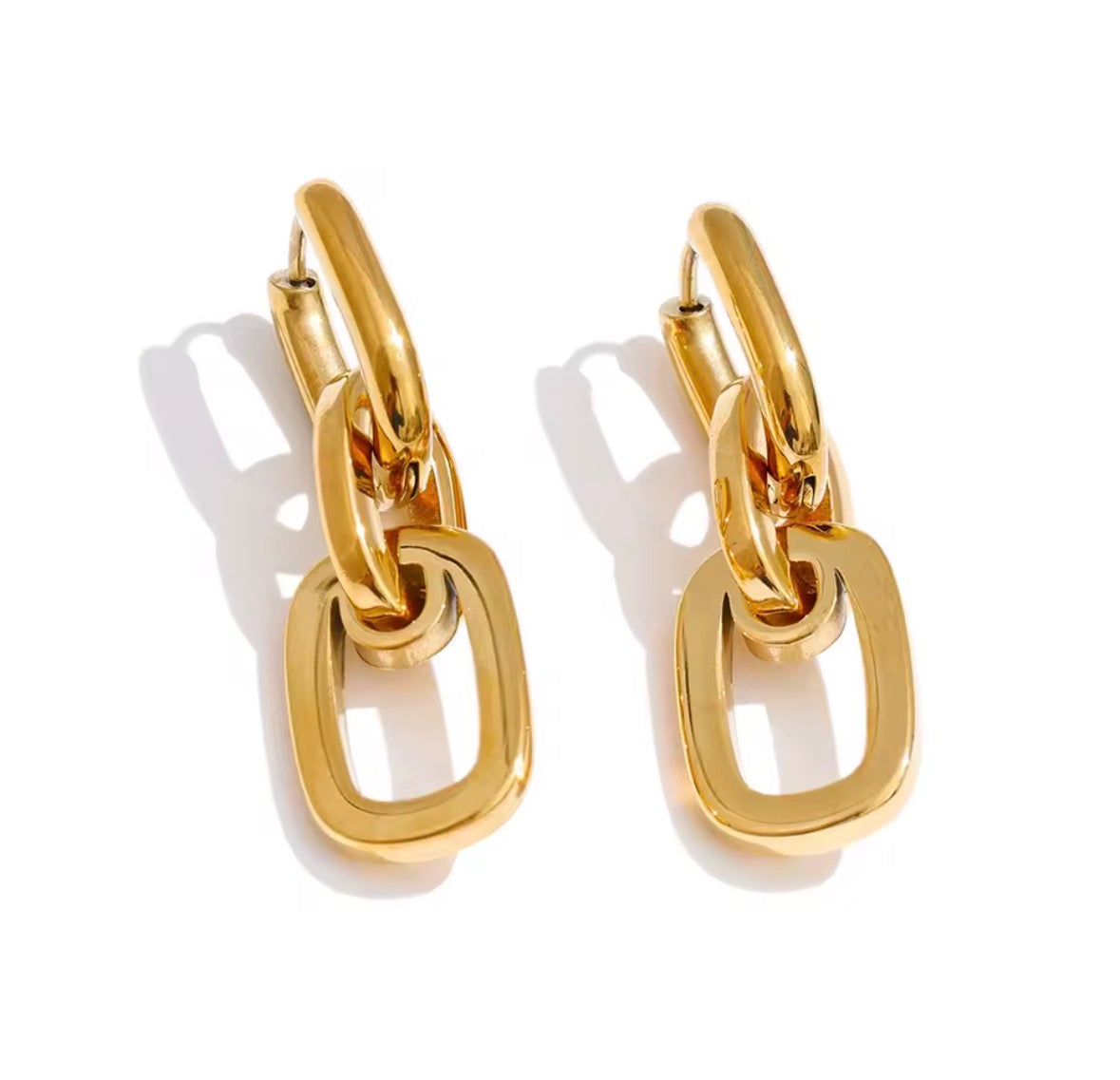 A pair of gold hoop earrings with large, open rectangular link charms, displayed on a clean white background with soft shadows.