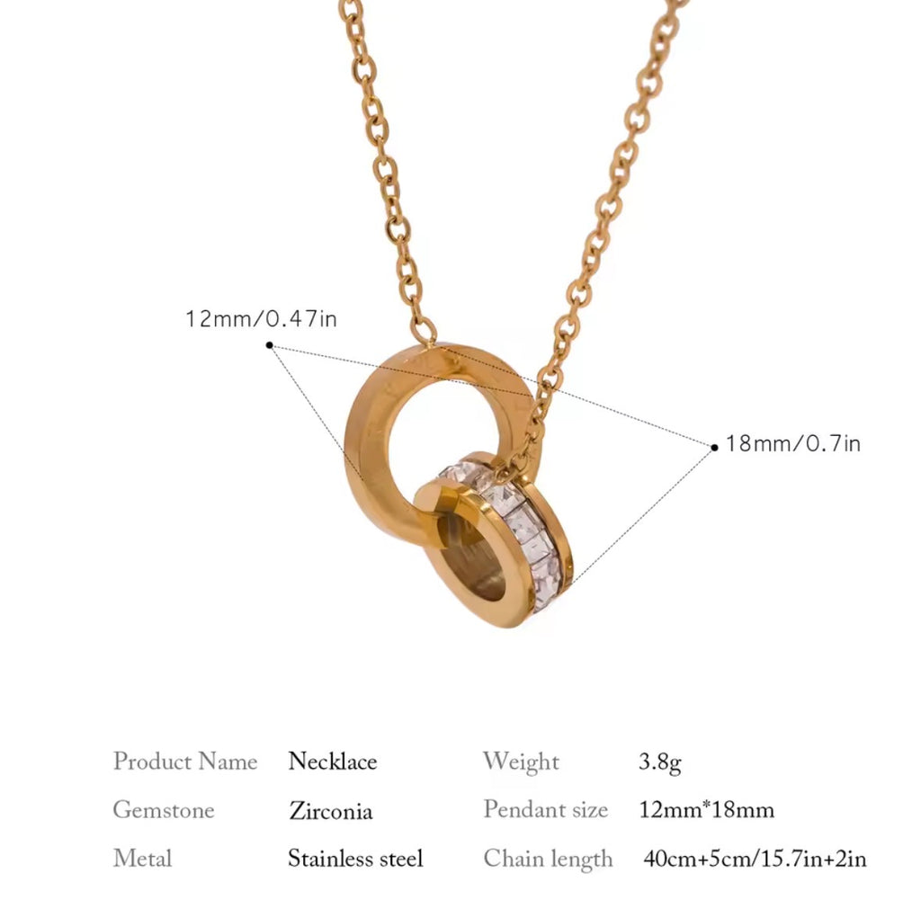 Shop The Eterna Necklace – a stainless steel interlocking circle pendant with sparkling cubic zirconia. Elegant, meaningful and perfect for everyday wear.