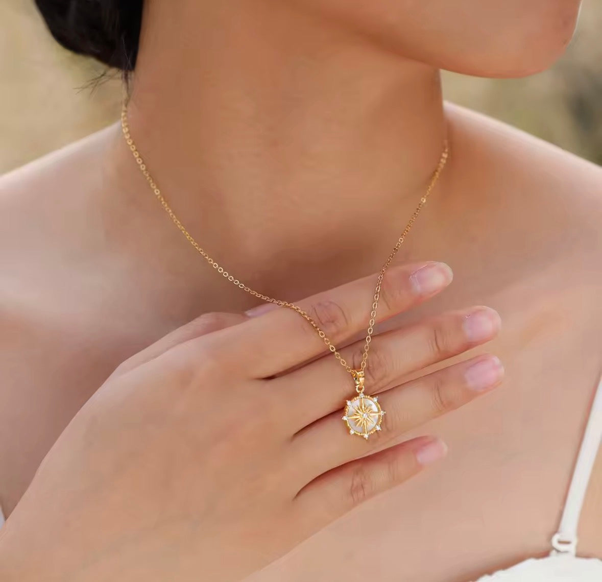 Shop The Polaris Necklace – an 18K PVD gold-plated stainless steel compass pendant with sparkling cubic zirconia. Waterproof, tarnish-resistant and hypoallergenic.
