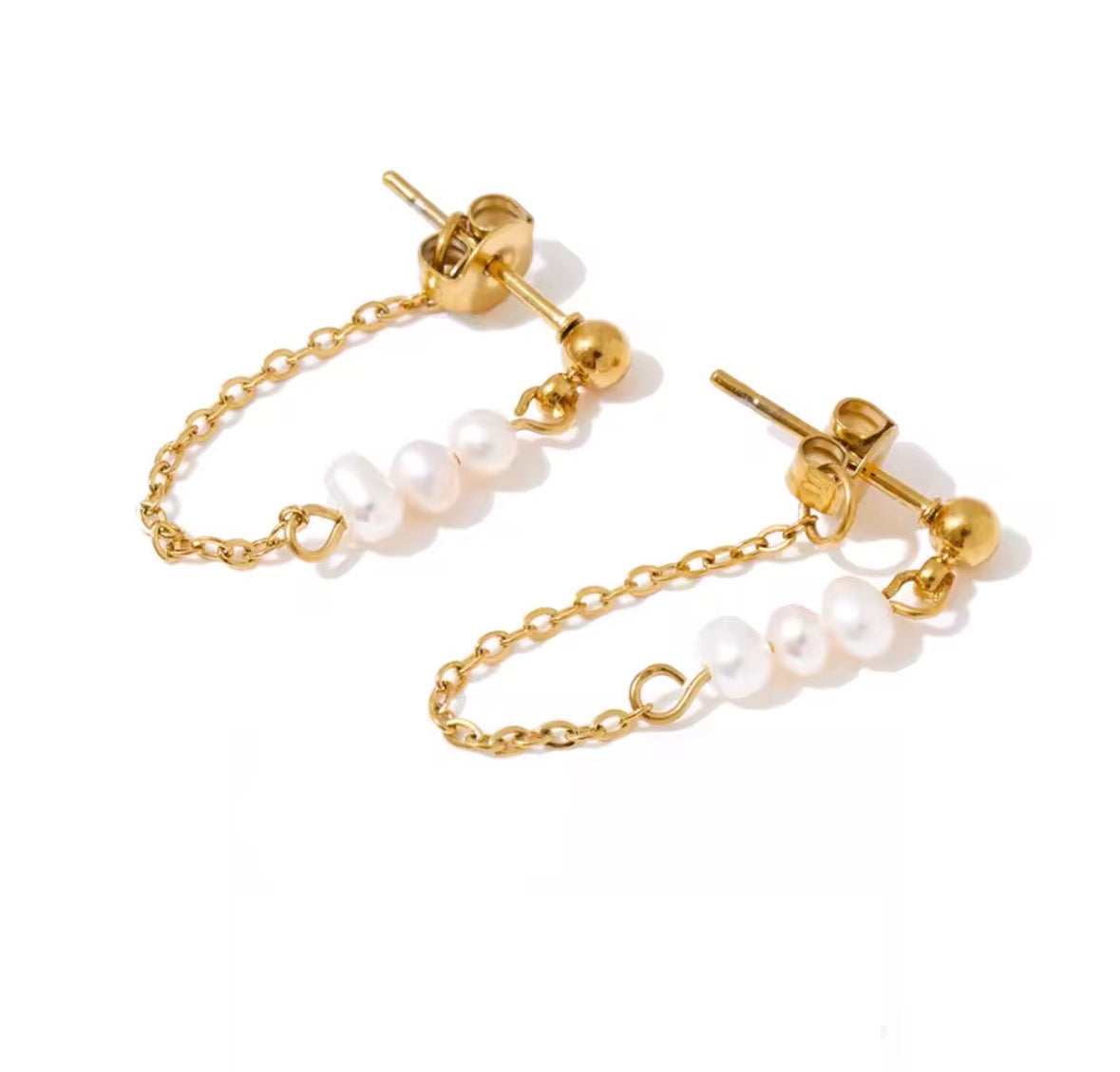 A pair of gold chain drop earrings with irregular white freshwater pearls, shown on a clean white background.