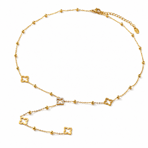 THE BLOOM NECKLACE A gold chain necklace featuring multiple small interlocking four-leaf clover motifs, with a central square link detail and an adjustable clasp, shown on a plain white background.