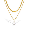 The Aurelia Necklace double layer gold necklace with a freshwater pearl on a white background