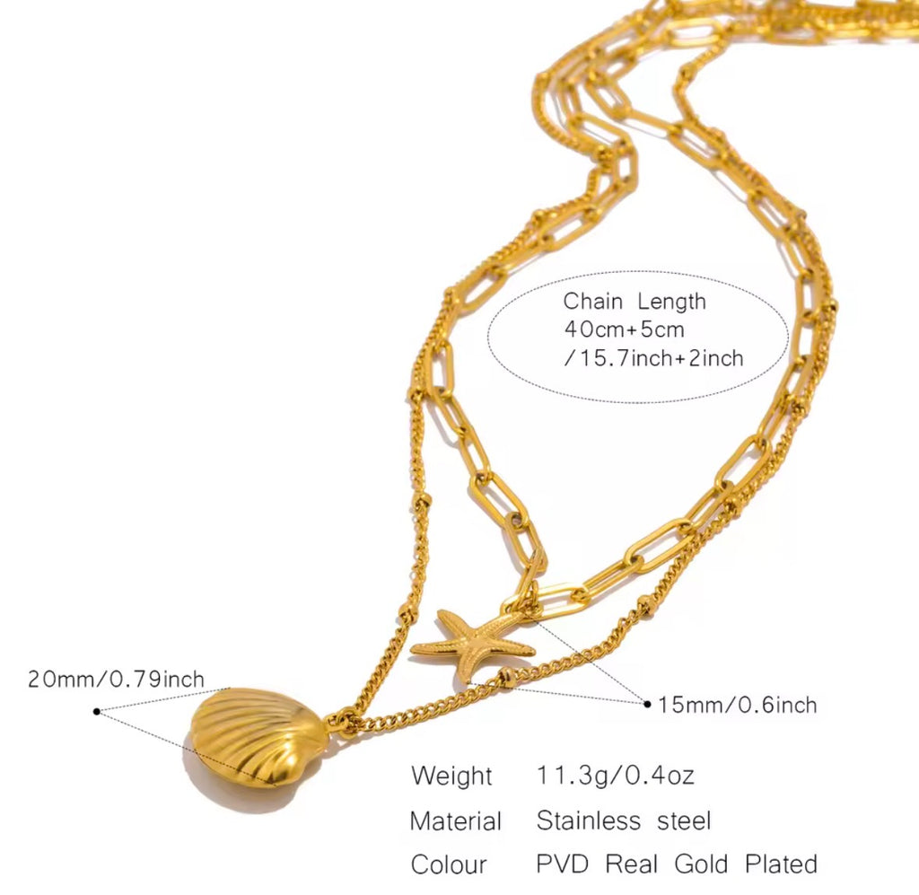 The Calypso Necklace Gold necklace with shell and starfish pendants on a white background