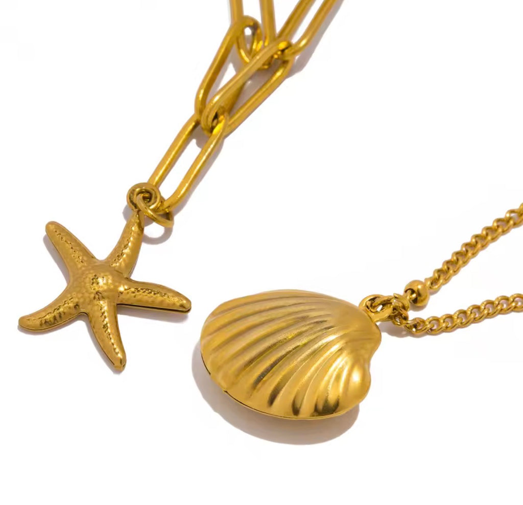 The Calypso Necklace:  Gold necklace with starfish and shell pendants on a white background