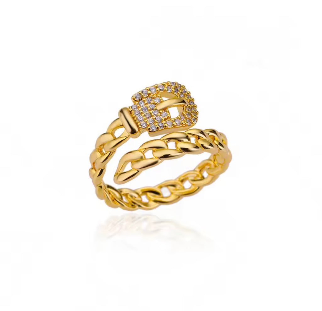 The Cintra Ring with a braided design and a buckle-like top on a white background
