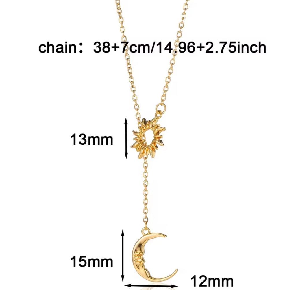 The Eclipse Necklace Gold necklace with sun and moon pendants and measurements on a white background