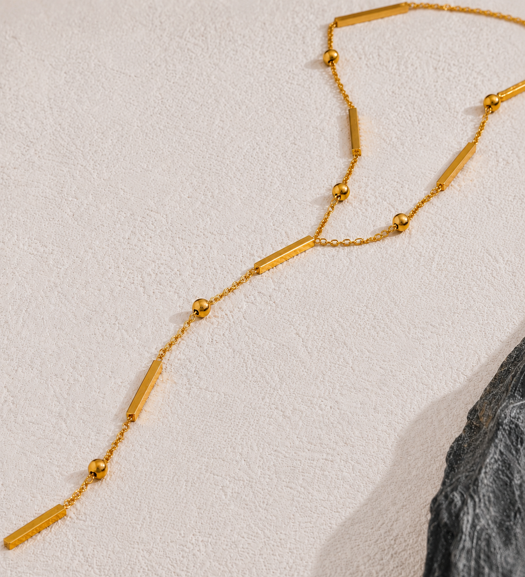 The Elisse Necklace details picture besides a black stone