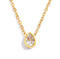 Gold necklace with a teardrop-shaped crystal pendant on a white background