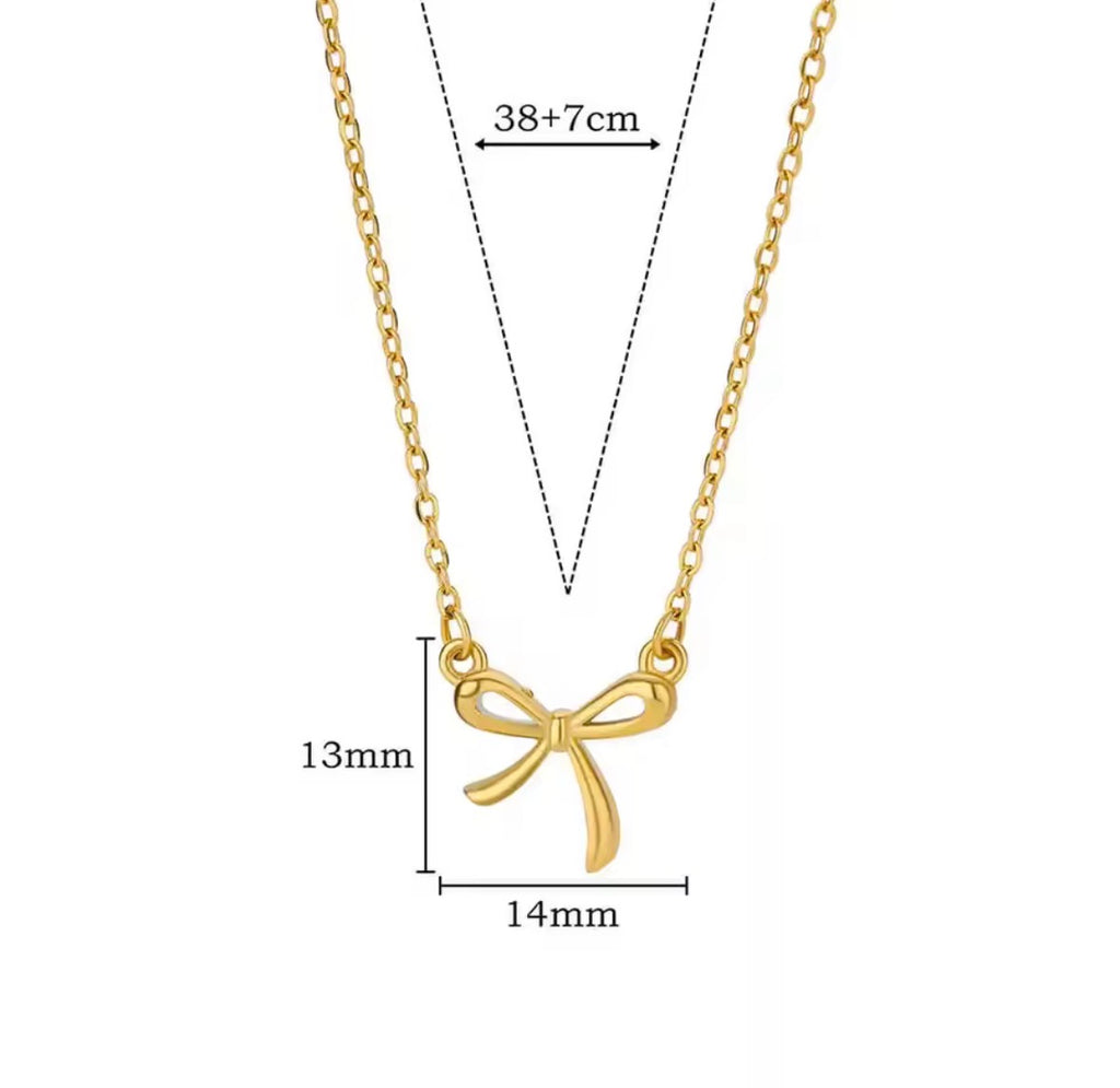 The Eloise Necklace Gold bow-shaped necklace with measurements on a white background