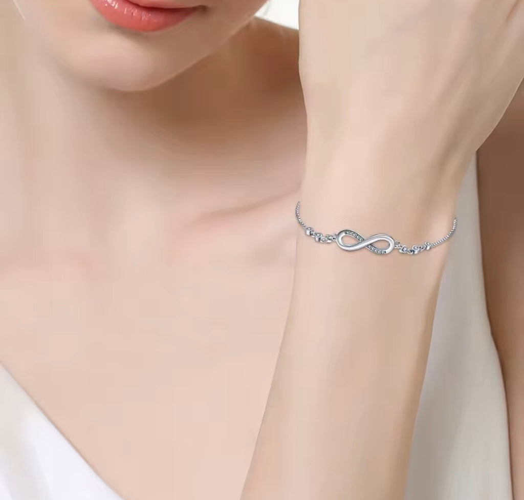 The Endless Love Bracelet  Silver bracelet with infinity design on a wrist against a neutral background