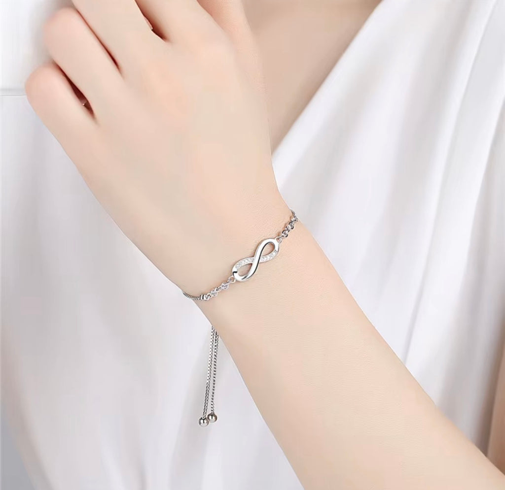 The Endless Love Bracelet Silver infinity bracelet on a person's wrist against a white background