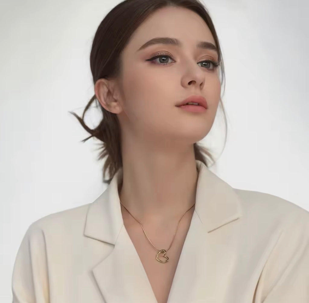 The Esmé Necklace   Woman wearing a beige blazer and gold necklace against a white background