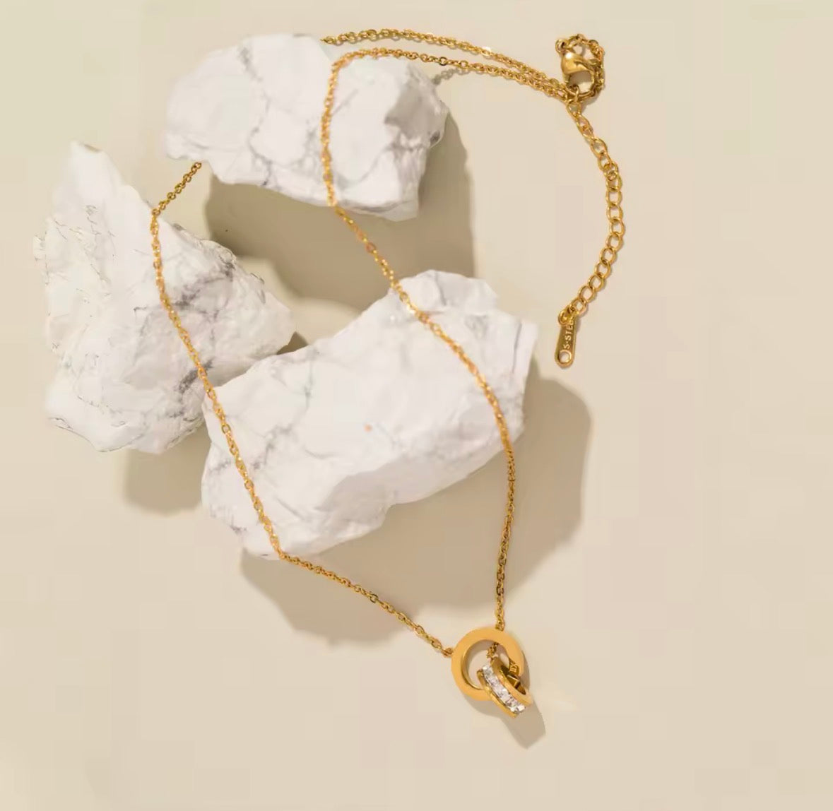 Shop The Eterna Necklace – a stainless steel interlocking circle pendant with sparkling cubic zirconia. Elegant, meaningful and perfect for everyday wear.