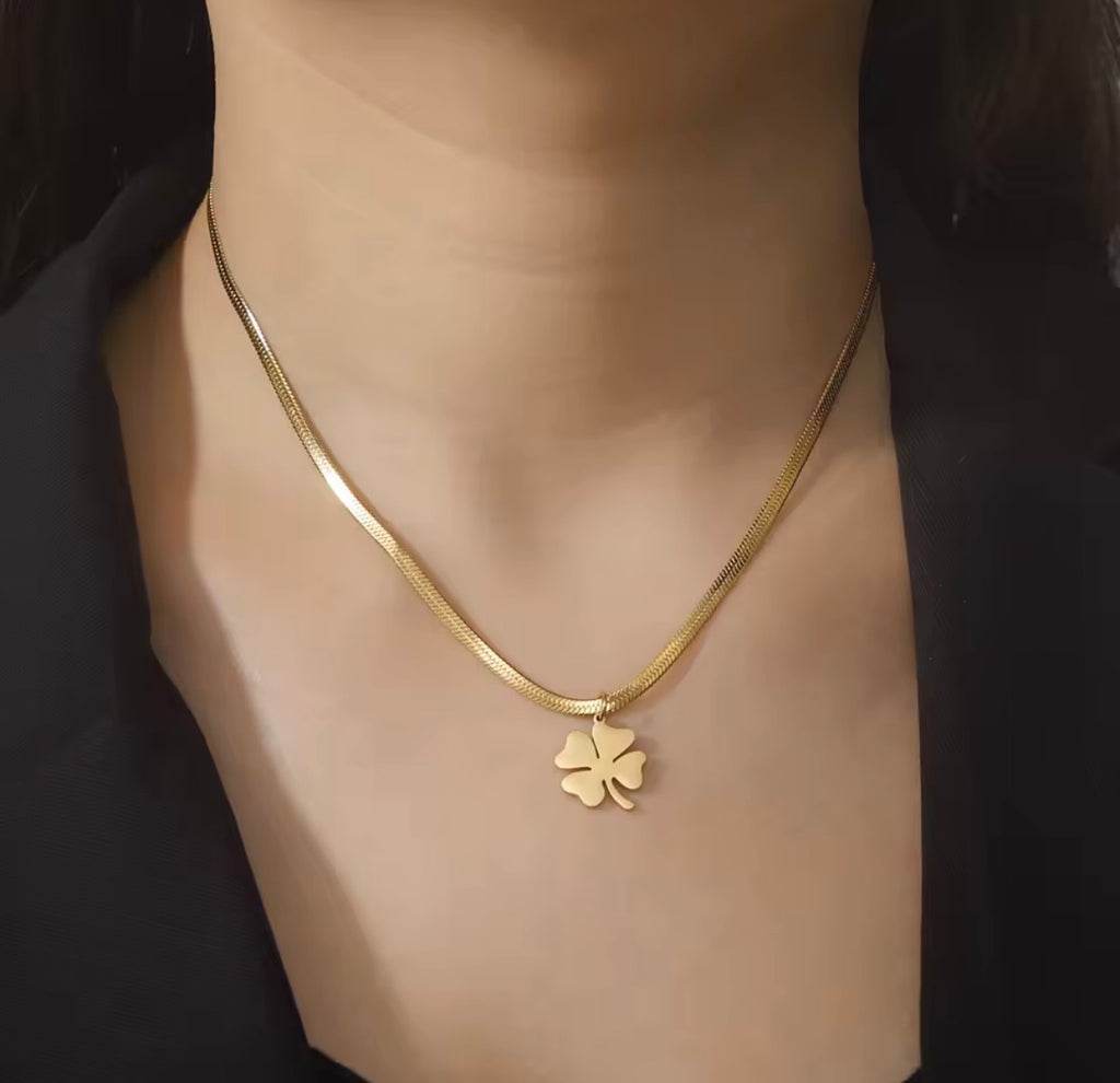 The Felicity Necklace with a clover pendant on a mannequin.