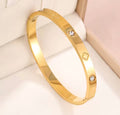 The Fortuna Clover Bangle with diamond accents on a soft background