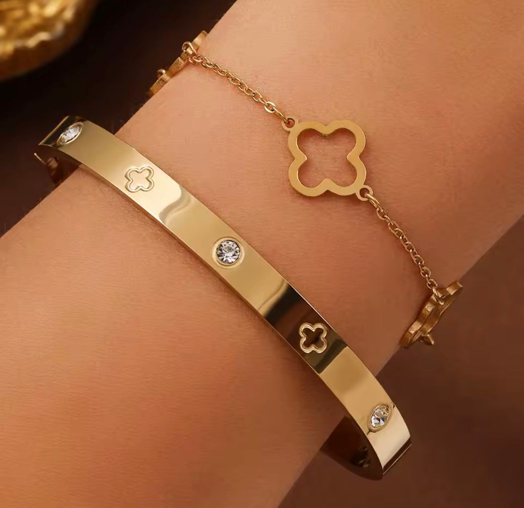 The Fortuna Clover bracelet with clover and gemstone details on a wrist against a dark background
