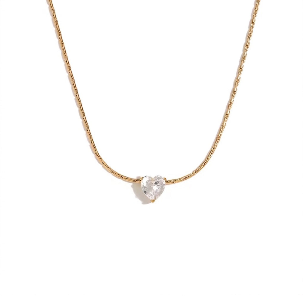 The Grace Necklace Gold necklace with a heart-shaped diamond pendant on a white background