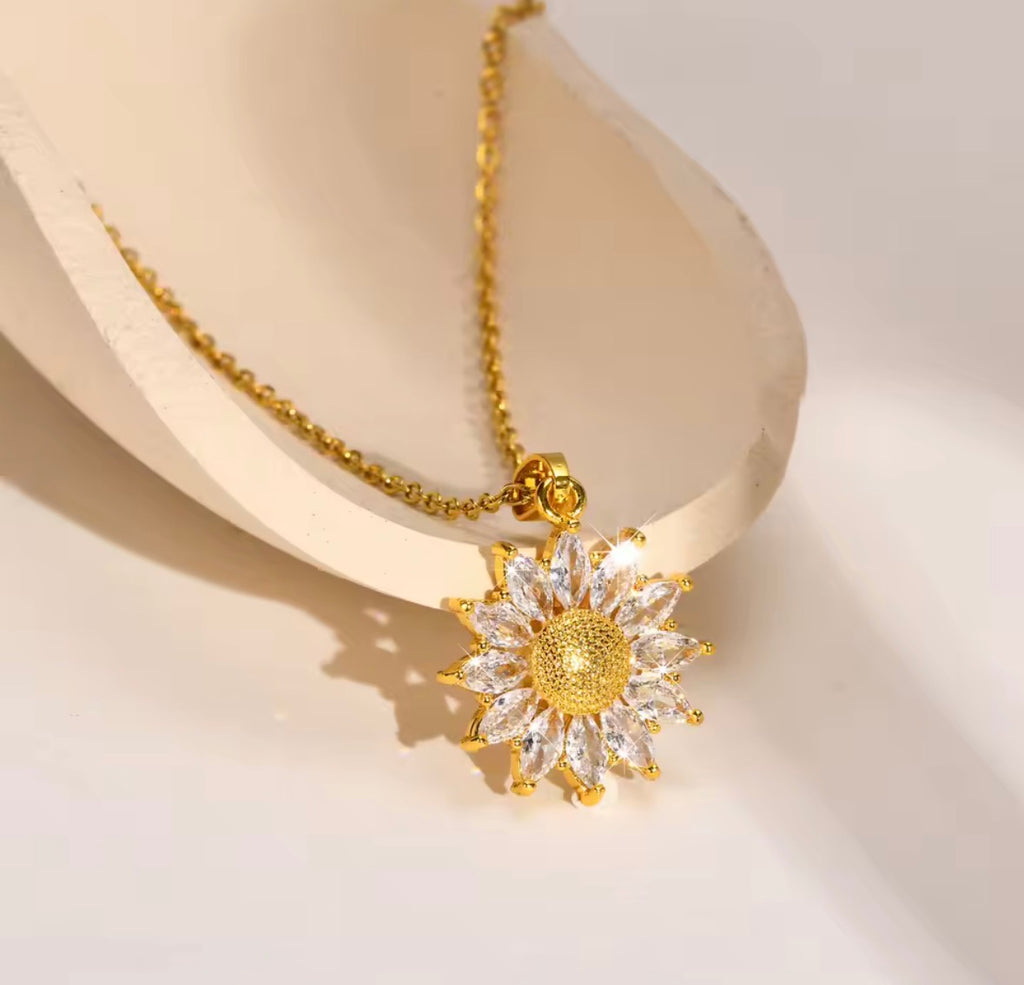 Shop The Helia Necklace, a waterproof stainless steel sunflower pendant necklace with 18K gold plating and sparkling crystal detail. Elegant and gift-worthy.