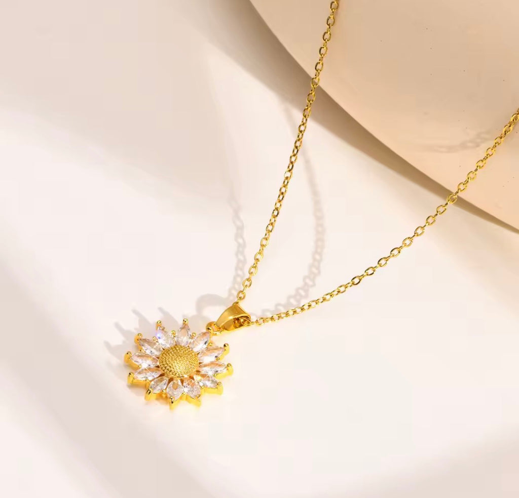 Shop The Helia Necklace, a waterproof stainless steel sunflower pendant necklace with 18K gold plating and sparkling crystal detail. Elegant and gift-worthy.