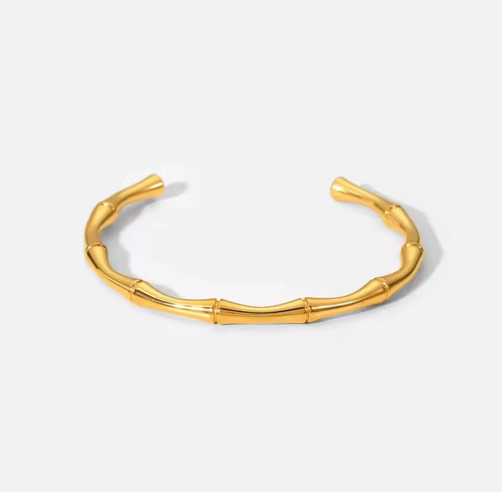 Shop The Kaori Bangle – a bamboo-inspired 316L stainless steel open bangle with 18K PVD gold plating. Waterproof, tarnish-resistant and hypoallergenic.