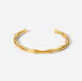 Shop The Kaori Bangle – a bamboo-inspired 316L stainless steel open bangle with 18K PVD gold plating. Waterproof, tarnish-resistant and hypoallergenic.