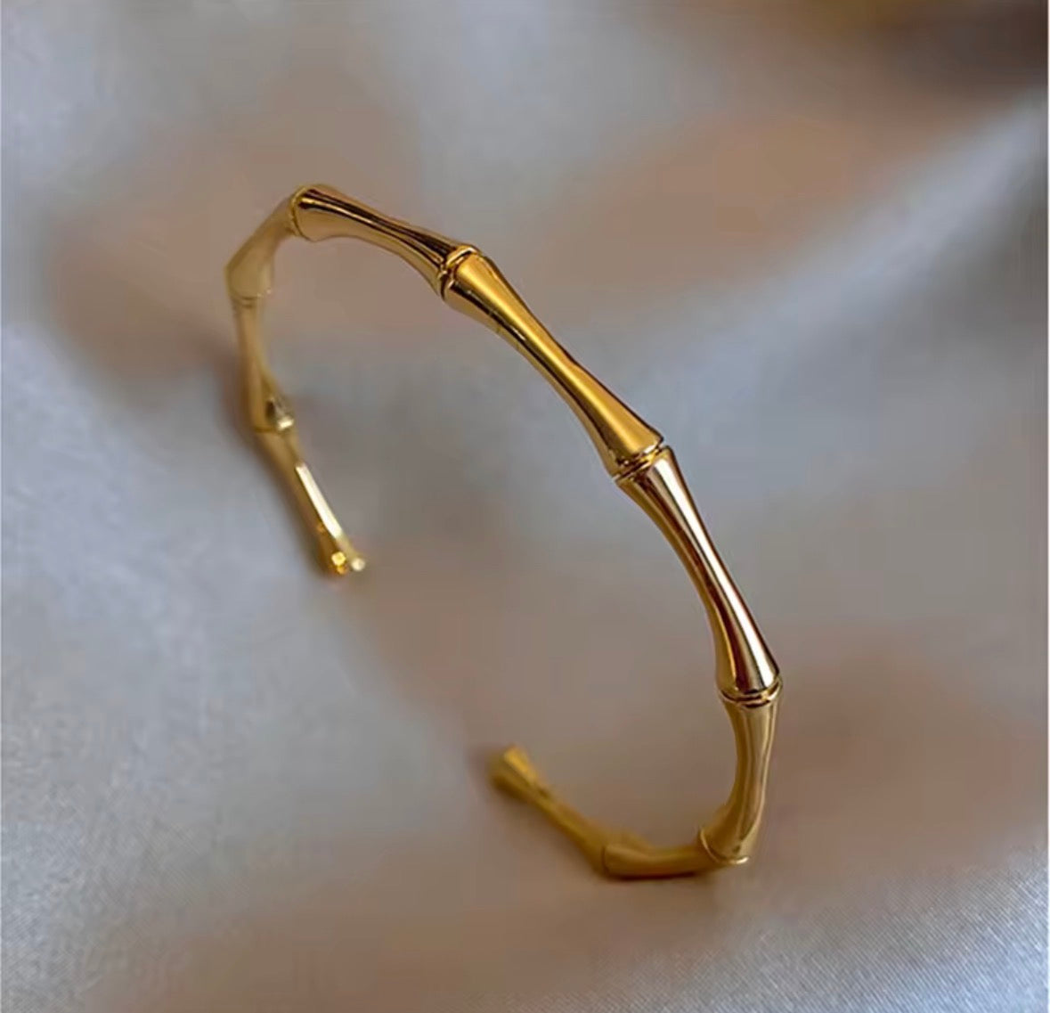 Shop The Kaori Bangle – a bamboo-inspired 316L stainless steel open bangle with 18K PVD gold plating. Waterproof, tarnish-resistant and hypoallergenic.