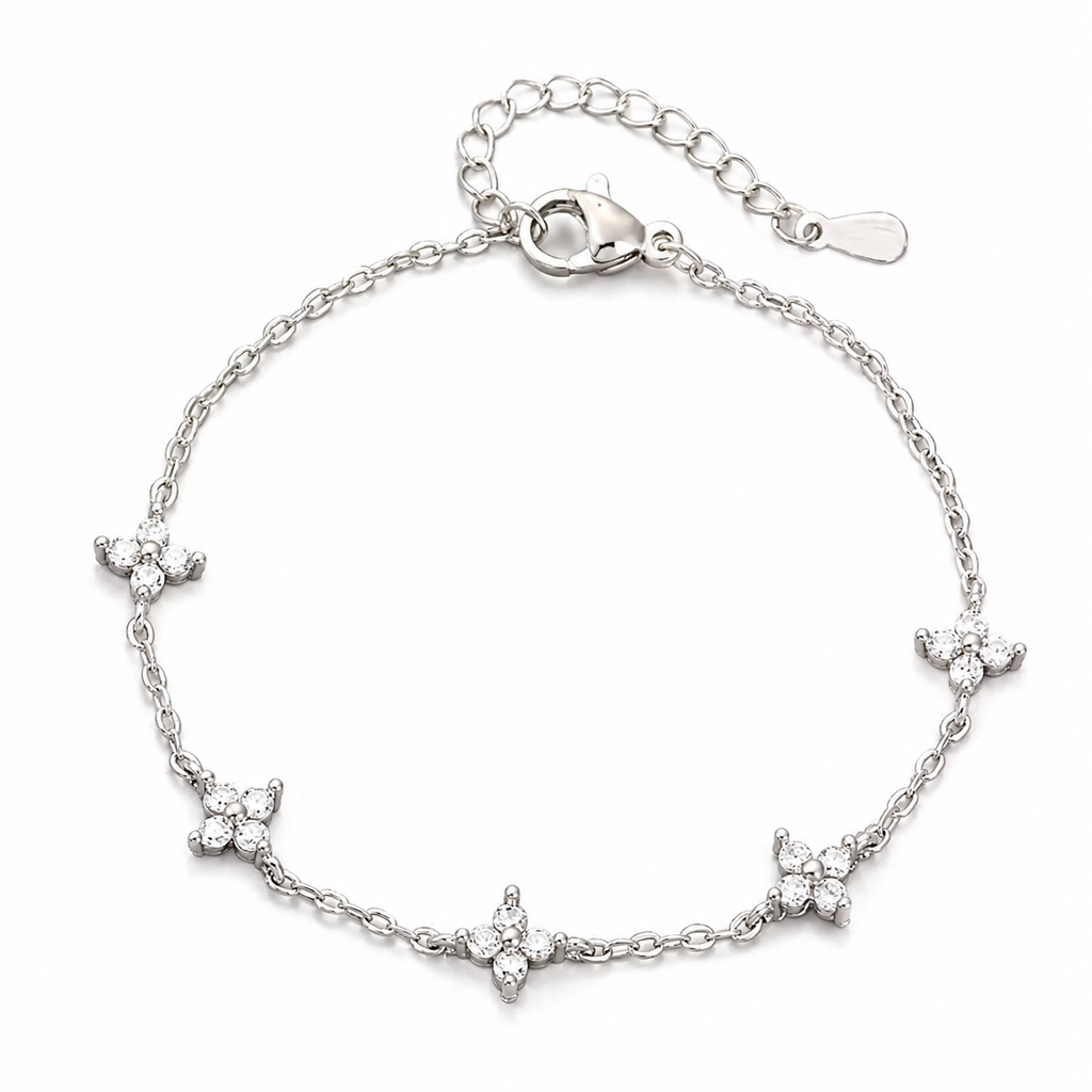 The Linnea bracelet A silver chain bracelet with five small flower motifs set with clear stones, displayed on a clean white background.