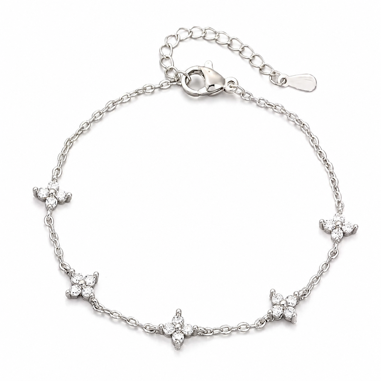The Linnea bracelet A silver chain bracelet with five small flower motifs set with clear stones, displayed on a clean white background.
