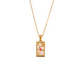 The Lovers Necklace: Gold necklace with tarot card pendant on a white background