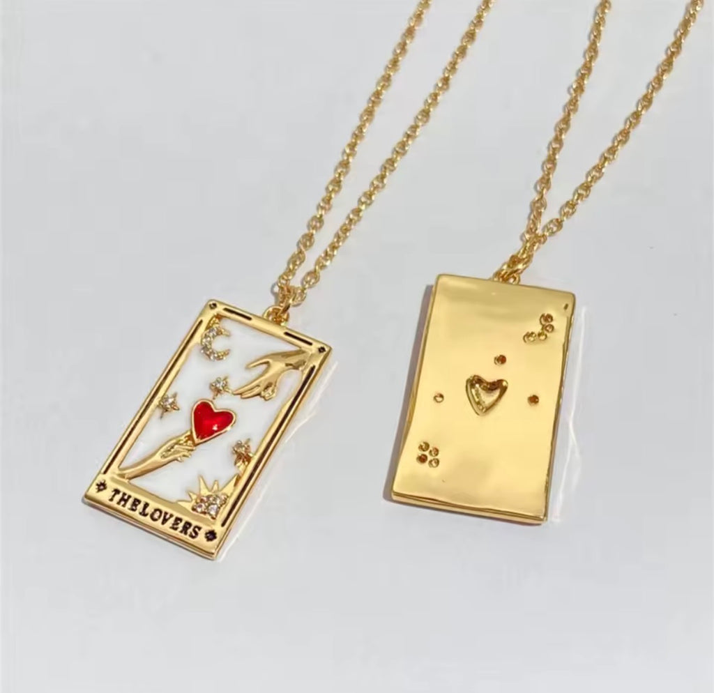 The Lovers Necklace two gold tarot card pendants on chains against a light gray background