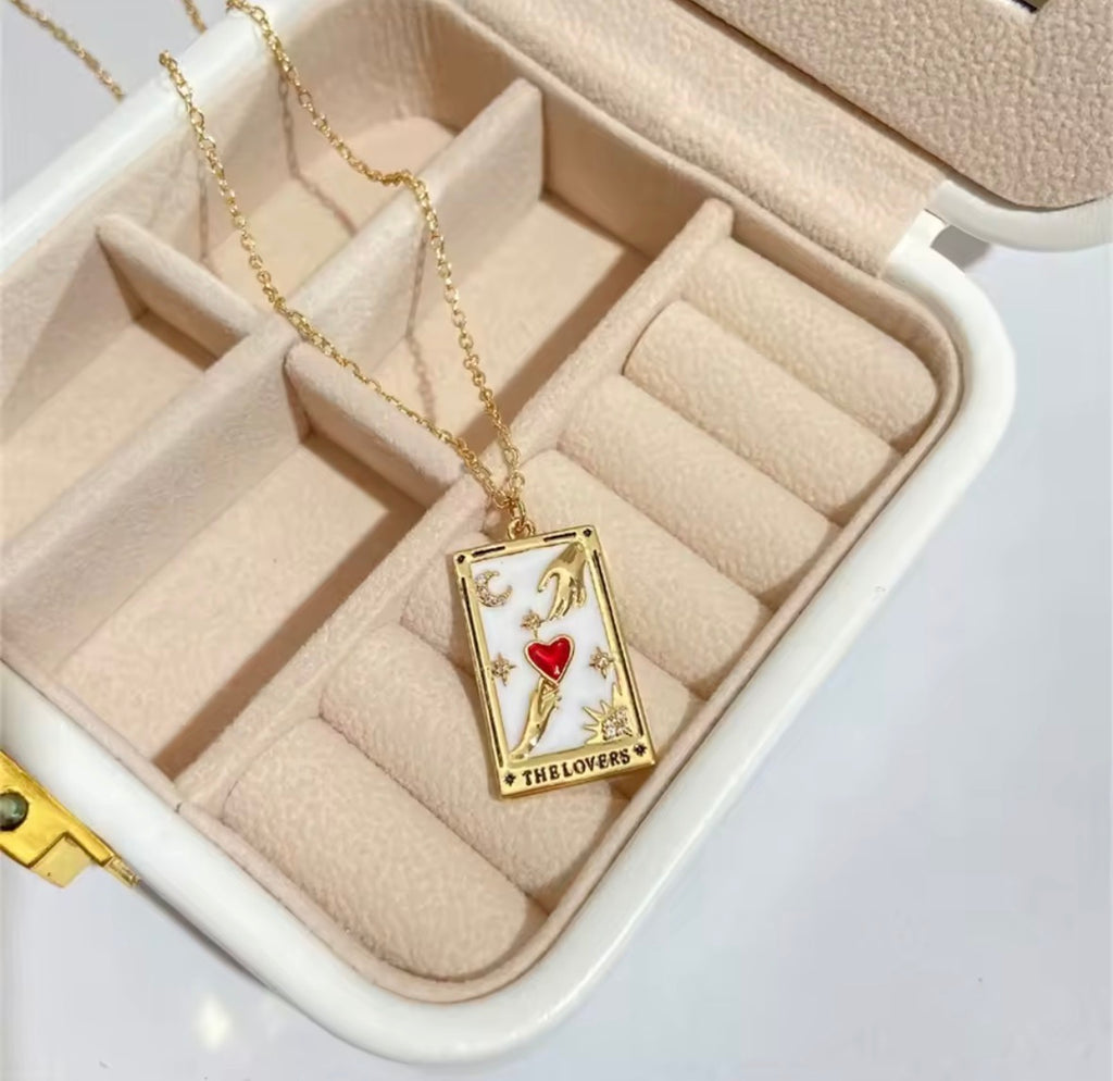 The Lovers Necklace with a card-themed pendant in an open jewelry box