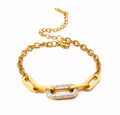 Shop The Maëva Bracelet – a bold 316L stainless steel link bracelet with 18K PVD gold plating and sparkling crystal detail. Waterproof and tarnish-resistant.