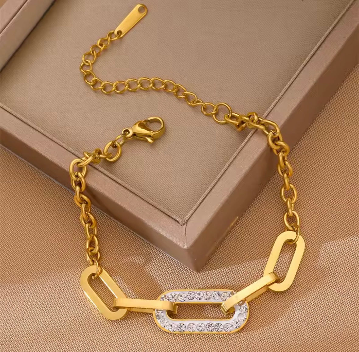 Shop The Maëva Bracelet – a bold 316L stainless steel link bracelet with 18K PVD gold plating and sparkling crystal detail. Waterproof and tarnish-resistant.