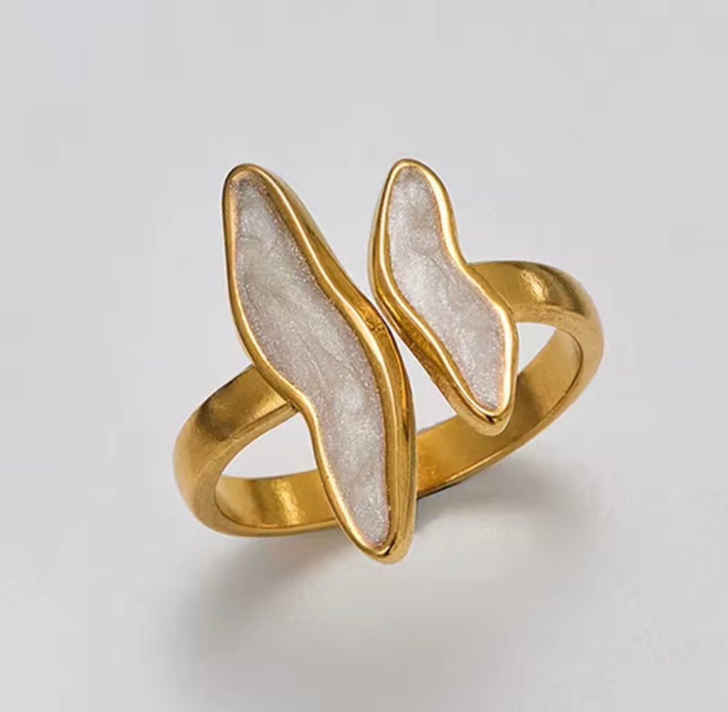The Ondine Ring Gold ring with a white stone on a light gray background