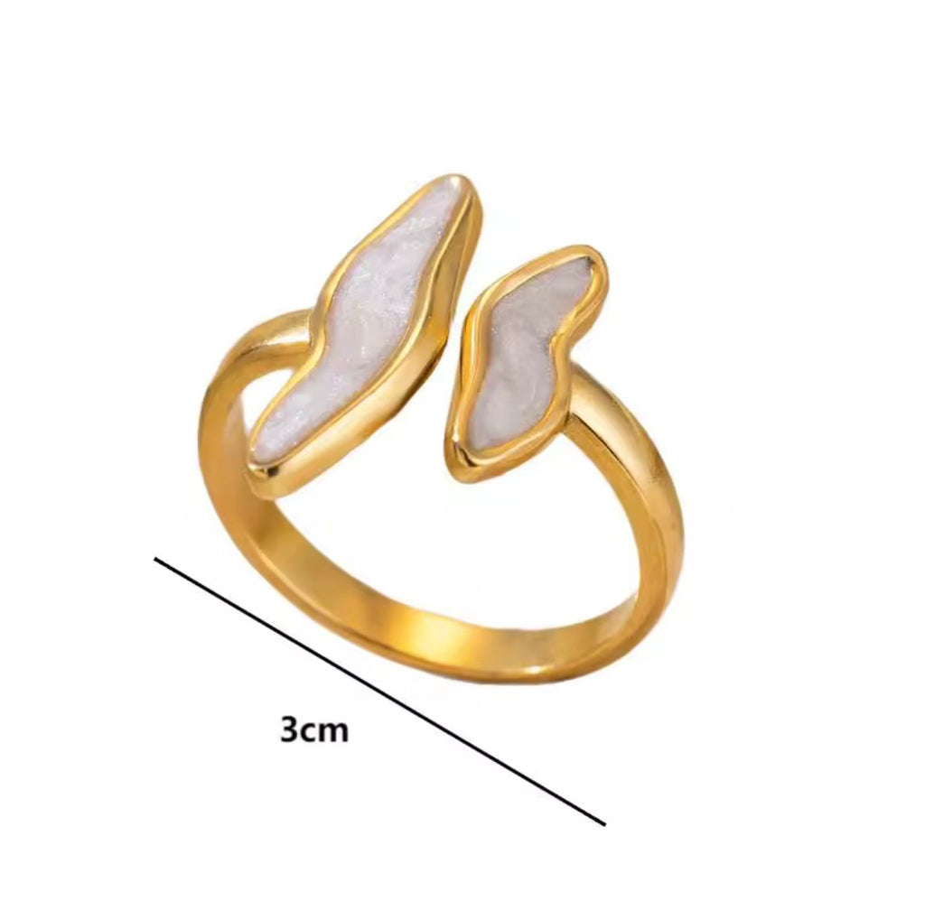 The Ondine Ring Gold ring with white stone wings on a white background