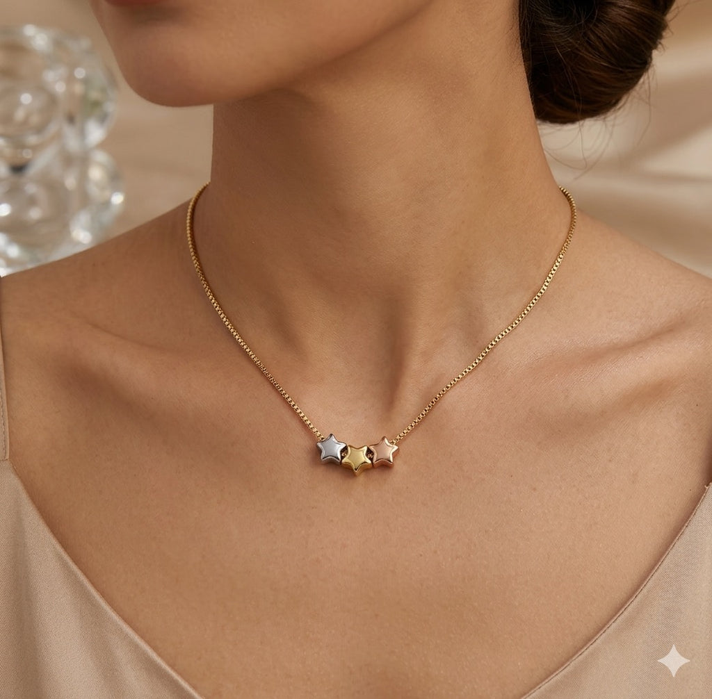 The Twinkle Necklace Necklace with star-shaped pendants worn by a person, with a neutral background