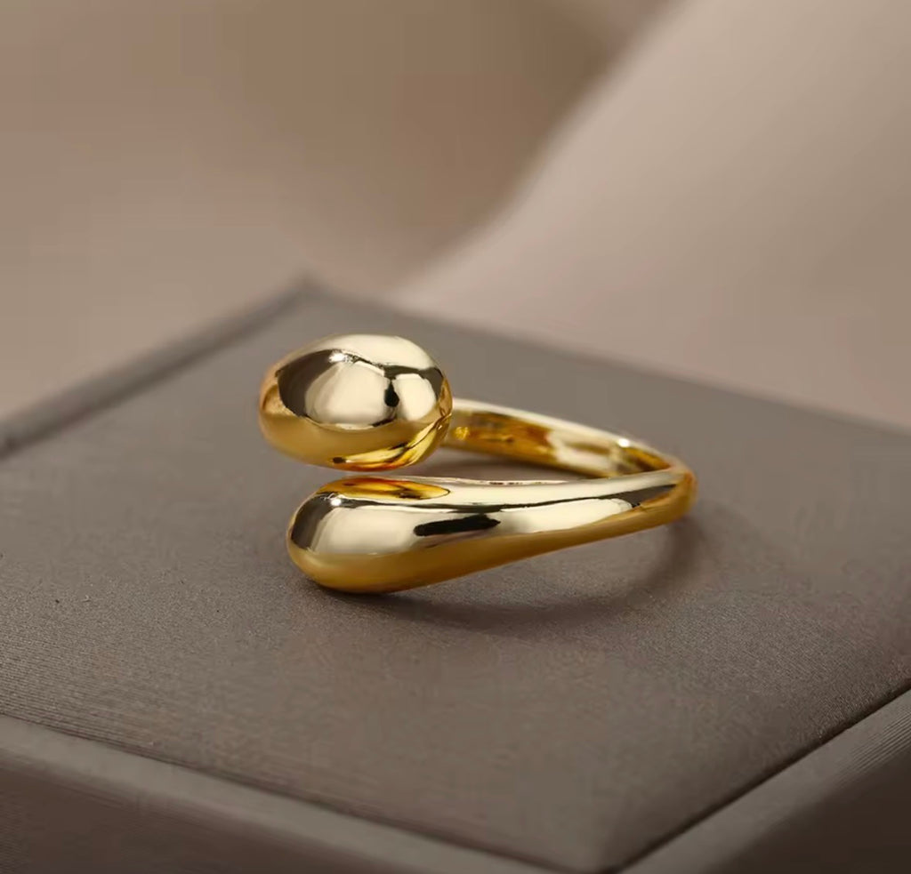 The Unity Ring on a textured surface with a neutral background