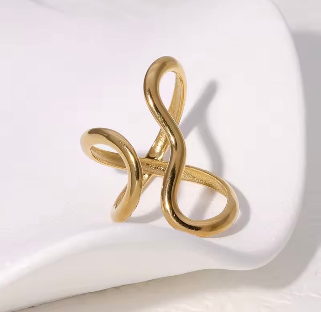 The Vaela Ring Gold ring with a unique design on a white surface