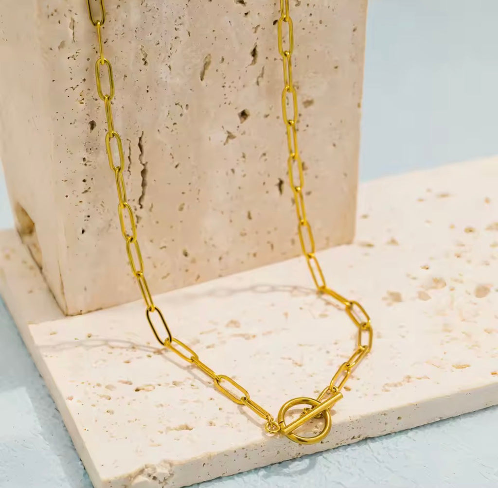 The Valiant chain necklace on a textured stone surface