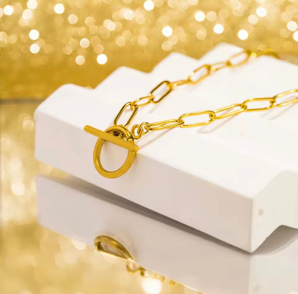 The Valiant chain necklace on a white box with a gold background