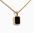The Vertex Necklace Gold necklace with a black pendant on a white background