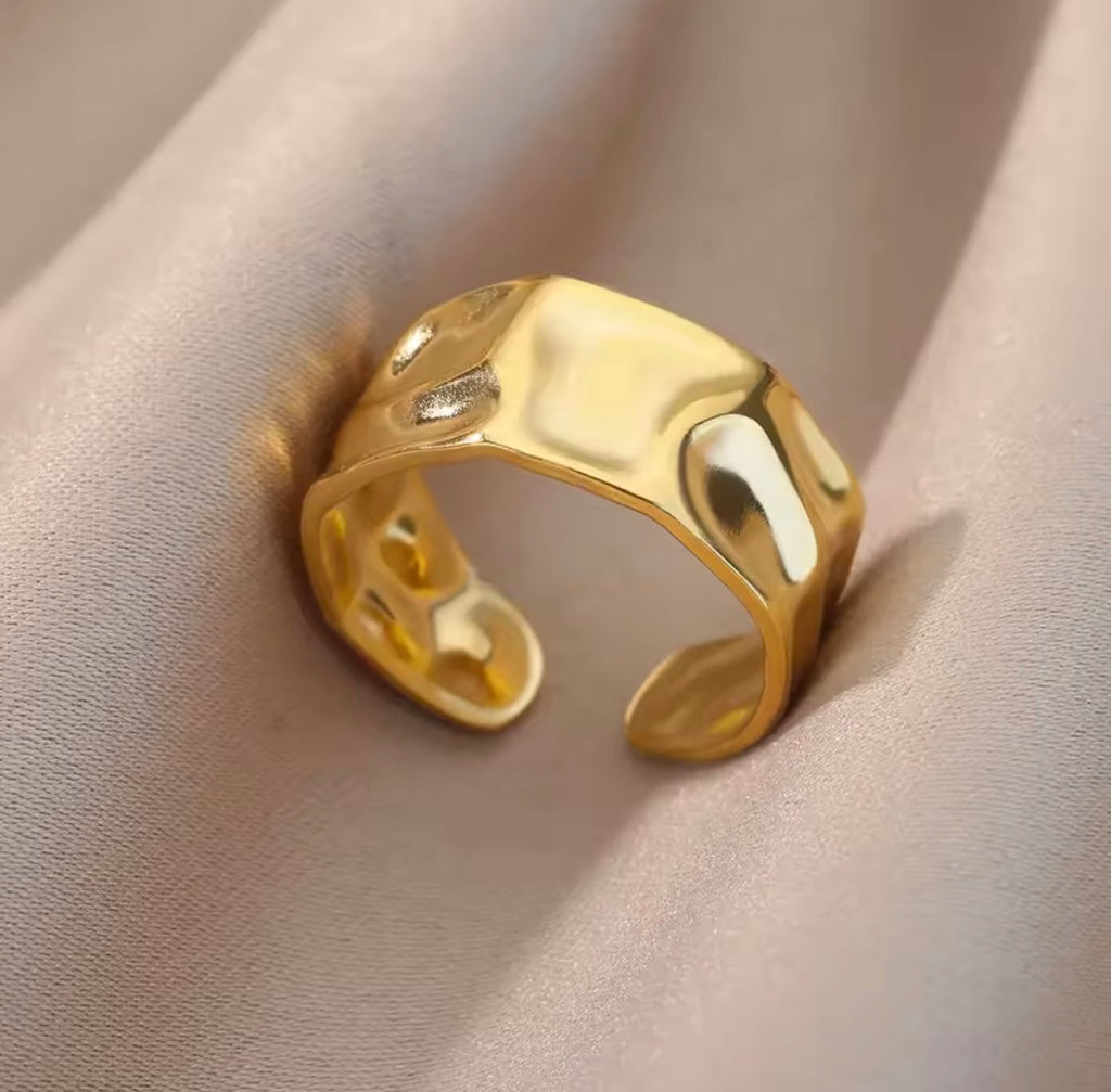 The Vesper Ring | Adjustable Textured Gold Statement Ring for Women Gold ring on a beige fabric background