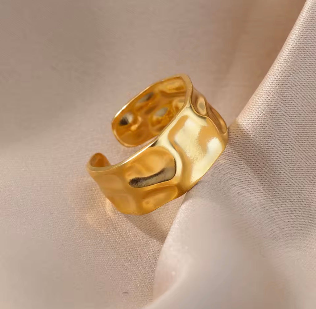 The Vesper Ring  Gold ring on a beige fabric background