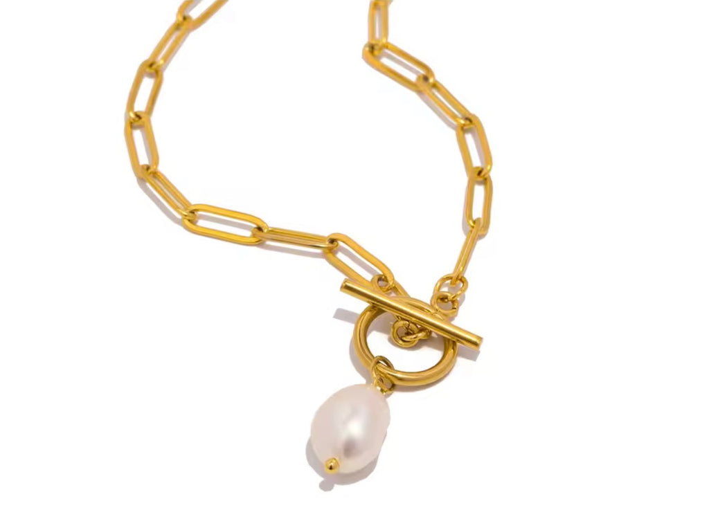 The Vivienne Pearl Necklace  Gold necklace with a pearl charm on a white background