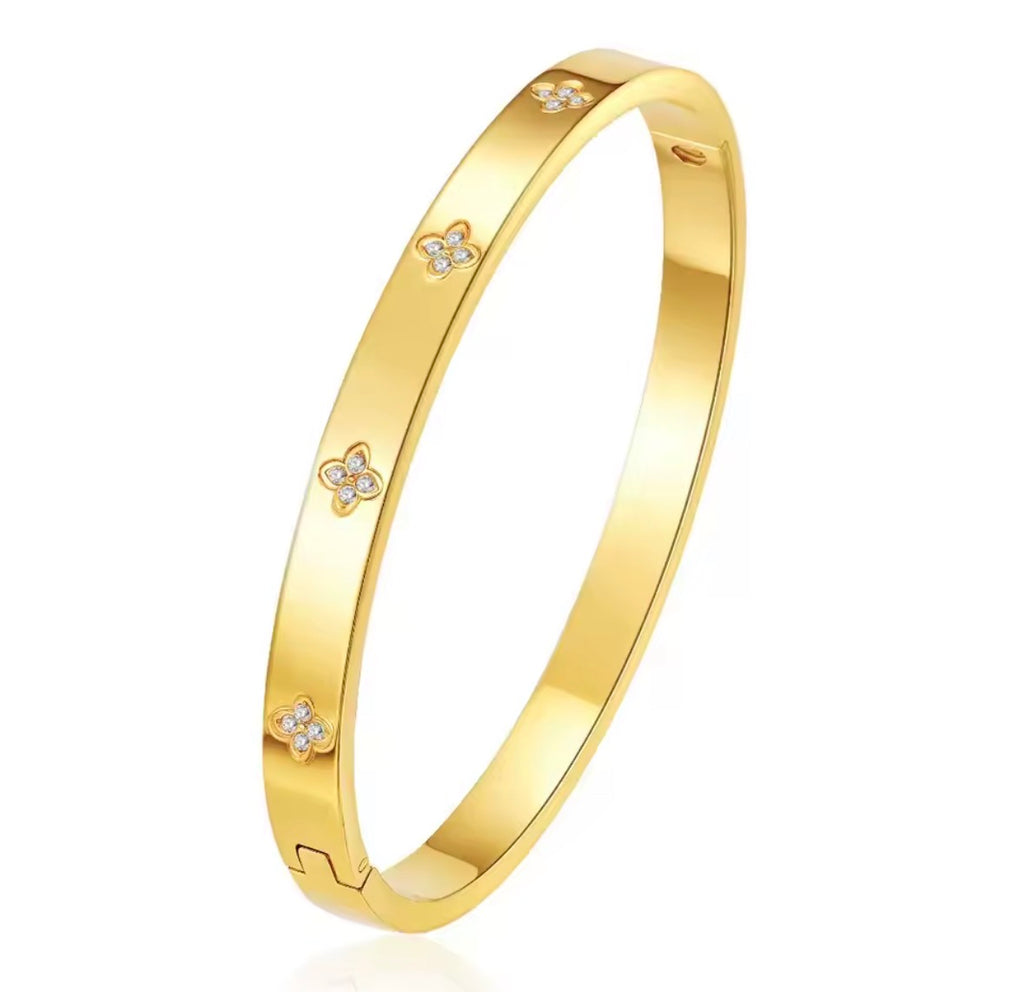 The Zaria Cuff bracelet with floral designs on a white background