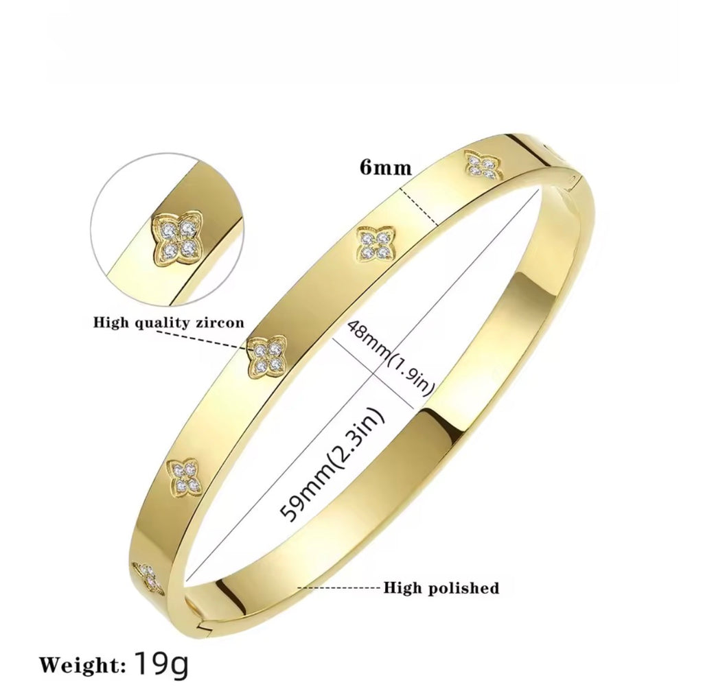 The Zaria Cuff bracelet with zirconia stones, showing measurements and quality details on a white background.