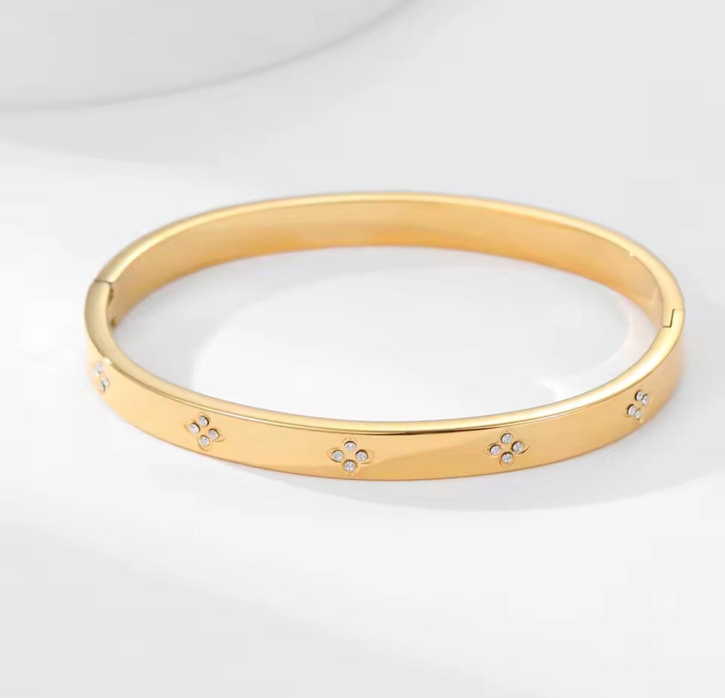 The Zaria Cuff bracelet with floral designs on a white background