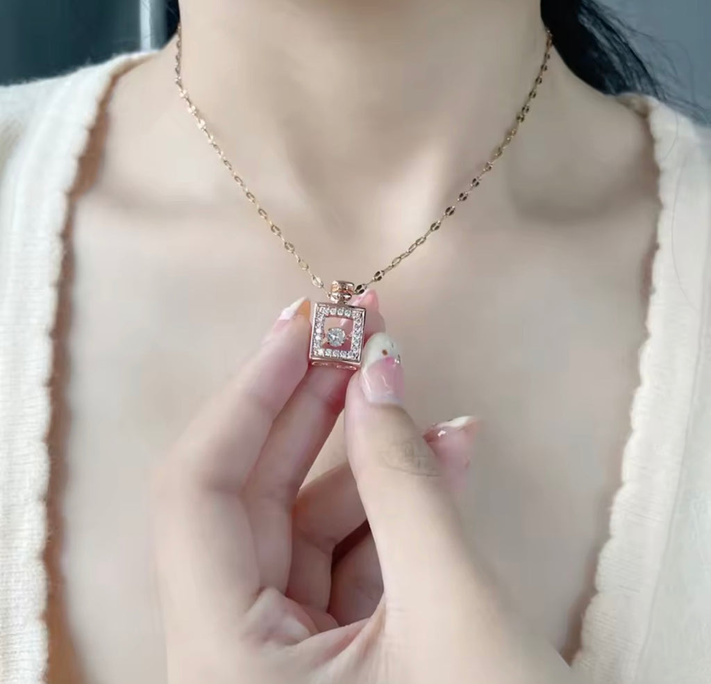 Woman Wearing The Sillage Gold Perfume Bottle Necklace

